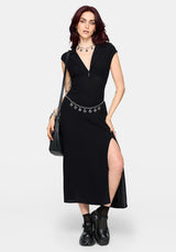 Woman wearing a black dress with a thigh slit on a white background