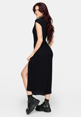 Woman wearing a black dress with a slit on a white background