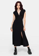 Woman wearing a black dress with a slit on a white background