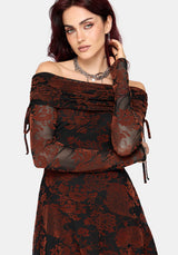 A woman modeling an off-the-shoulder long-sleeve dress with a black and rust-brown floral jacquard pattern, sheer mesh sleeves, and side tie details, set against a plain light gray background.