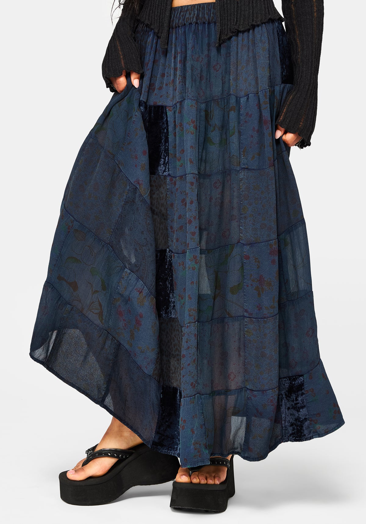 Navy blue layered skirt worn by a person on a white background