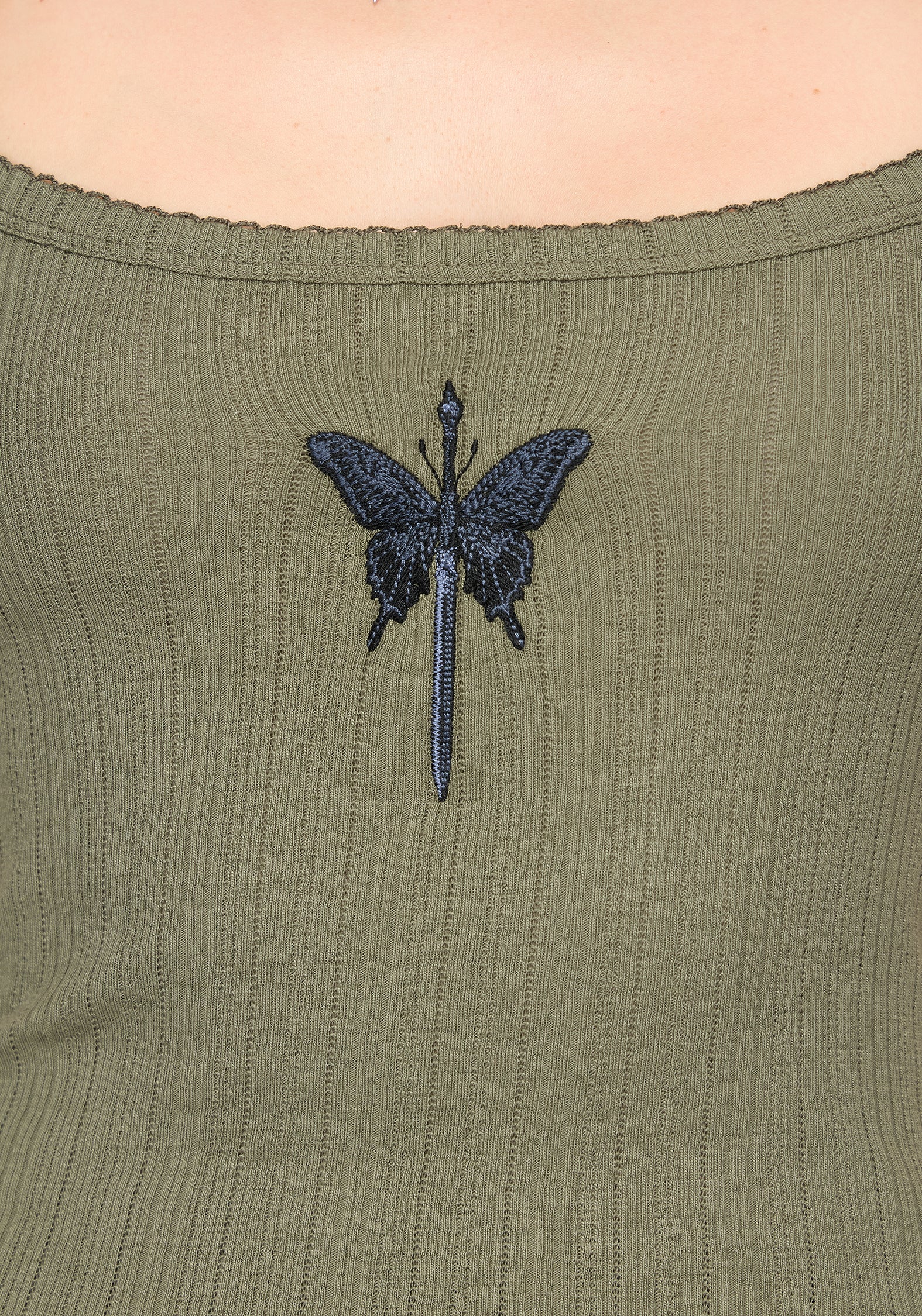 Close up detail of blue embroidery butterfly detail on khaki vest